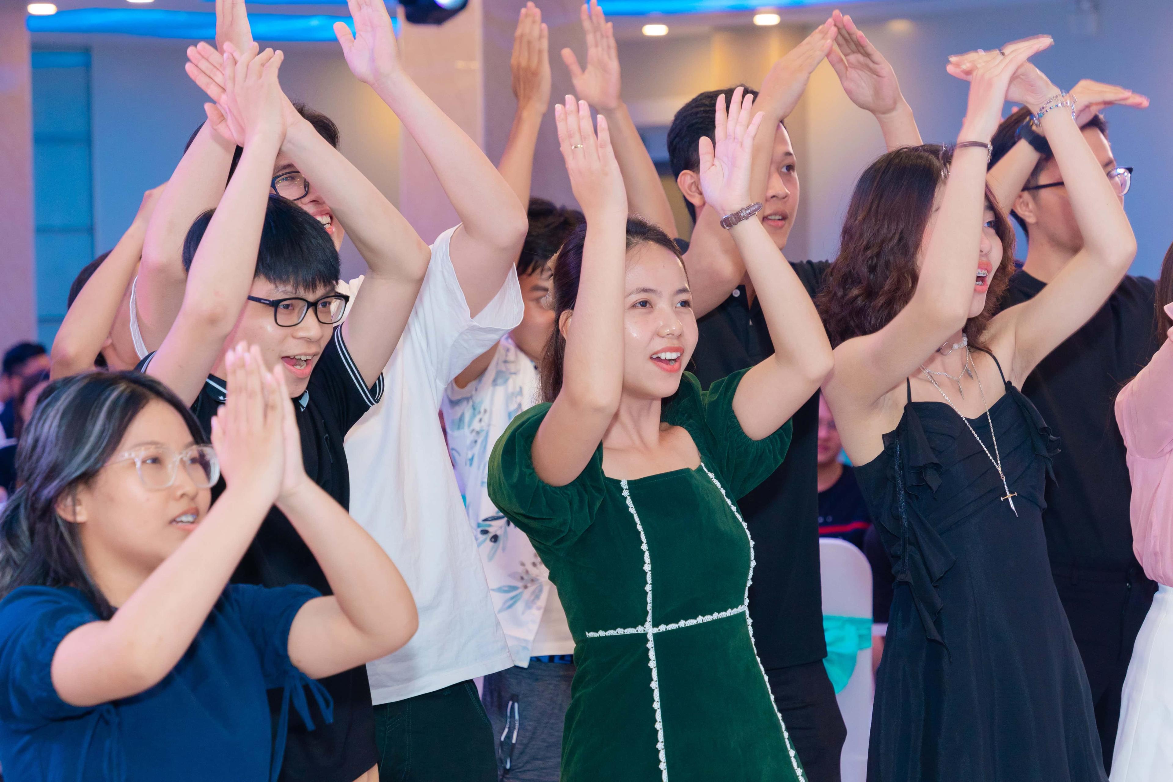Group of ELCA Vietnam employees dancing and clapping